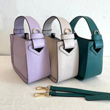Three handbags in purple, beige, and green on a light background