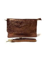 Brown metallic leather clutch bag with a matching strap on a white background