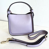 Purple handbag with a matching strap on a white background