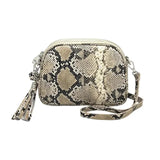 Snake print handbag with a tassel on a white background