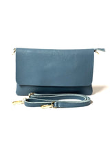 Blue leather handbag with a strap on a white background