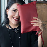 Model holding Red pebbled leather clutch