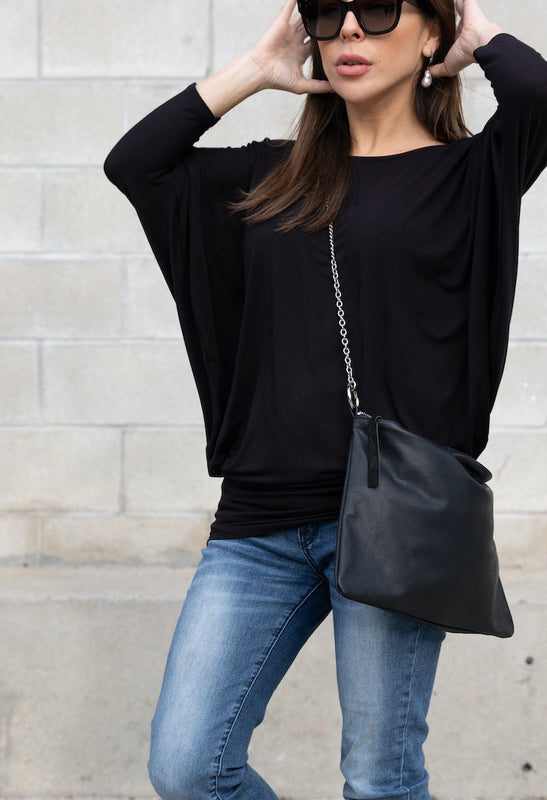Model Carrying Lux Leather Bag and wearing Bamboo Dolman, Baroque Pearl Earrings.