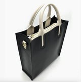 Black handbag with white handles on a white background