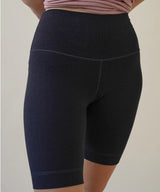 Black shorts worn by a person on a plain background
