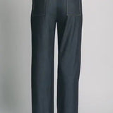 Dark denim pants on a light gray background
