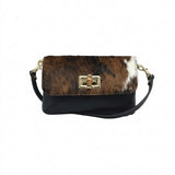 Baguette style handbag with black and brown cowhide on a white background