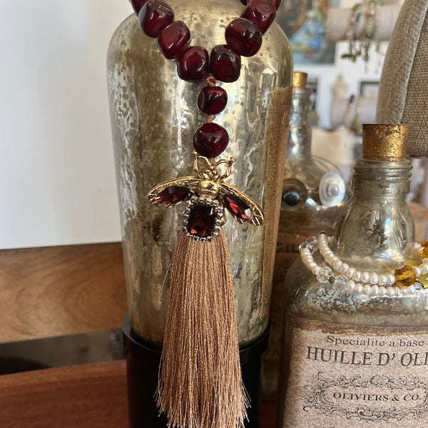 Decorative Beaded loop accessory hanging on a bottle.