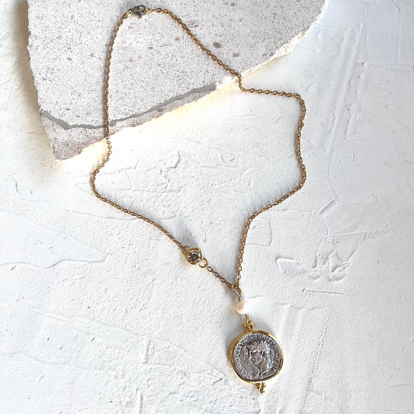 Necklace with a pendant on a textured white surface