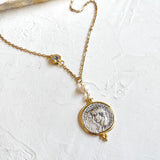 Necklace with a coin-shaped pendant on a white background