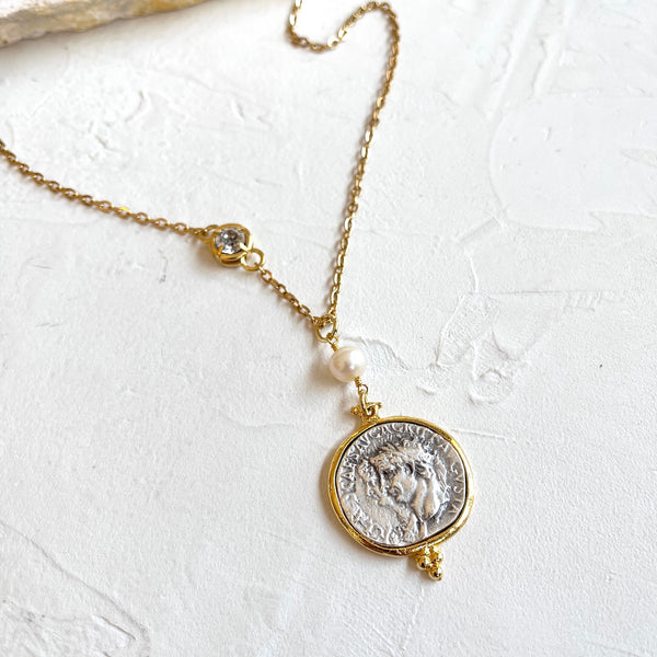 Necklace with a coin-shaped pendant on a white background
