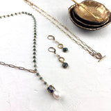 Jewelry set including necklace and earrings on a white surface