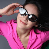 Girl  with hot pink top wearing black sunglasses